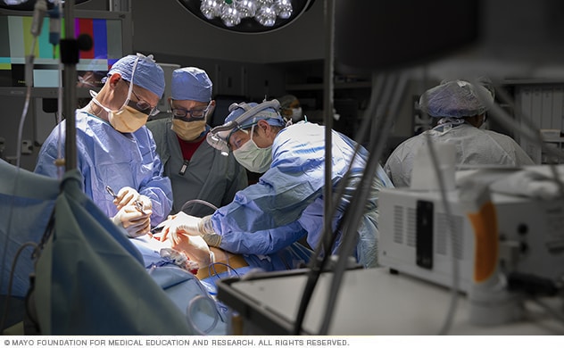 A team of surgeons treat a patient