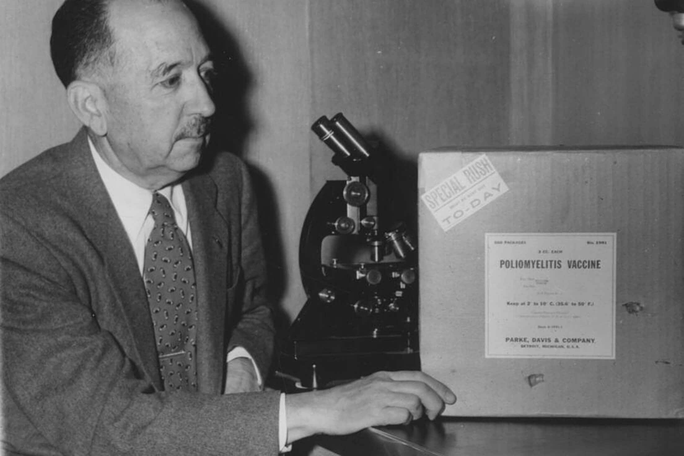 Dr. Thomas Magath sits at a desk looking at the first shipment of the polio vaccine at Mayo Clinic