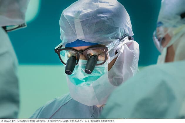 An Orthopedic Oncology surgeon uses magnified lenses during a procedure.