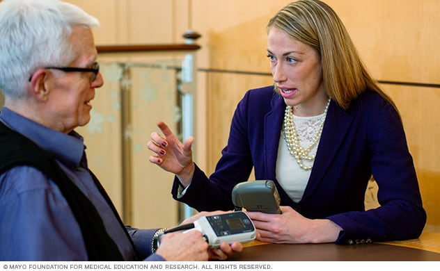 A VAD coordinator discusses a ventricular assist device with a person.