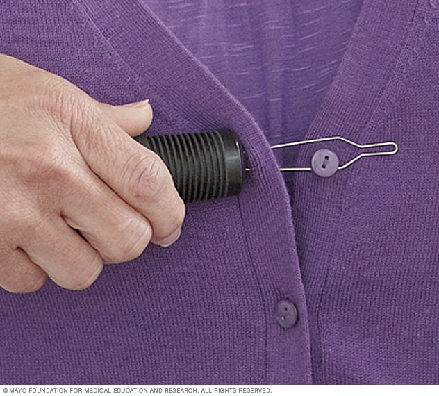 Photograph of a person using a buttonhook