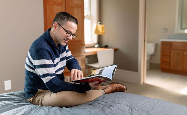 A resident of the John E. Herman Home and Treatment Facility reads in his room.