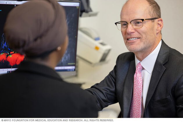 A Mayo Clinic surgical oncologist discusses novel therapies and surgical techniques with a patient. 