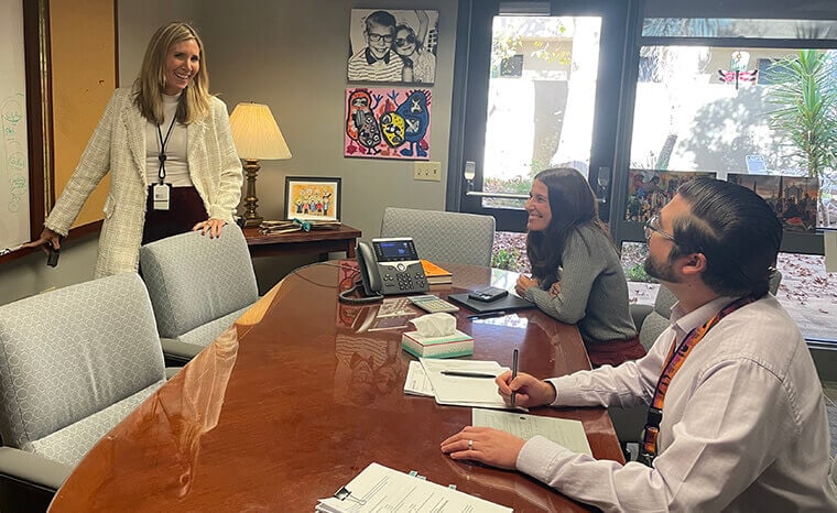 Chief Executive Officer Mimi Coomler discusses strategy with colleagues.