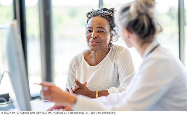 A woman reviews results with her doctor