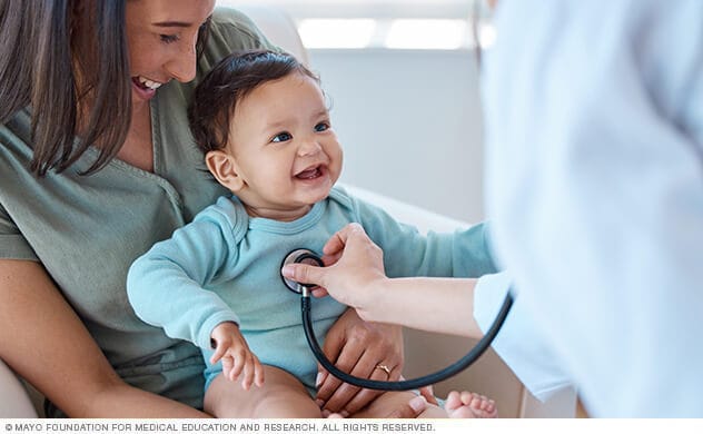 A doctor examines a baby 