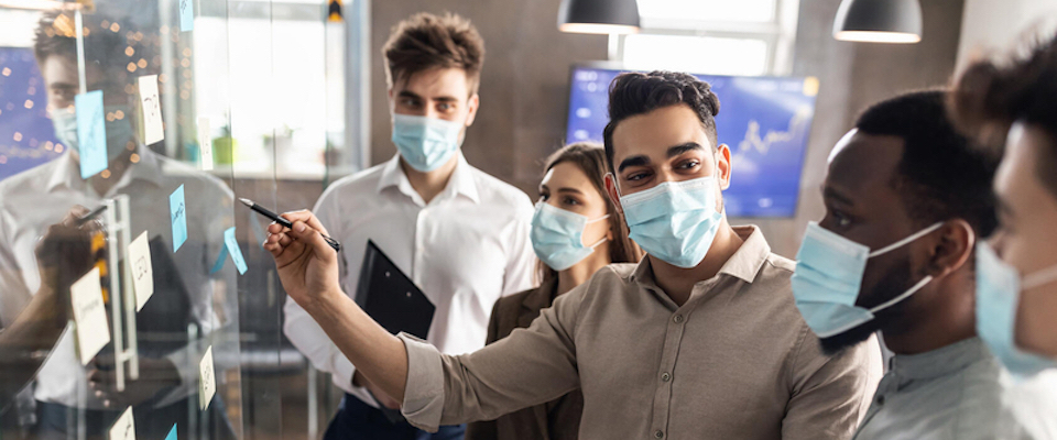 Masked researchers collaborating